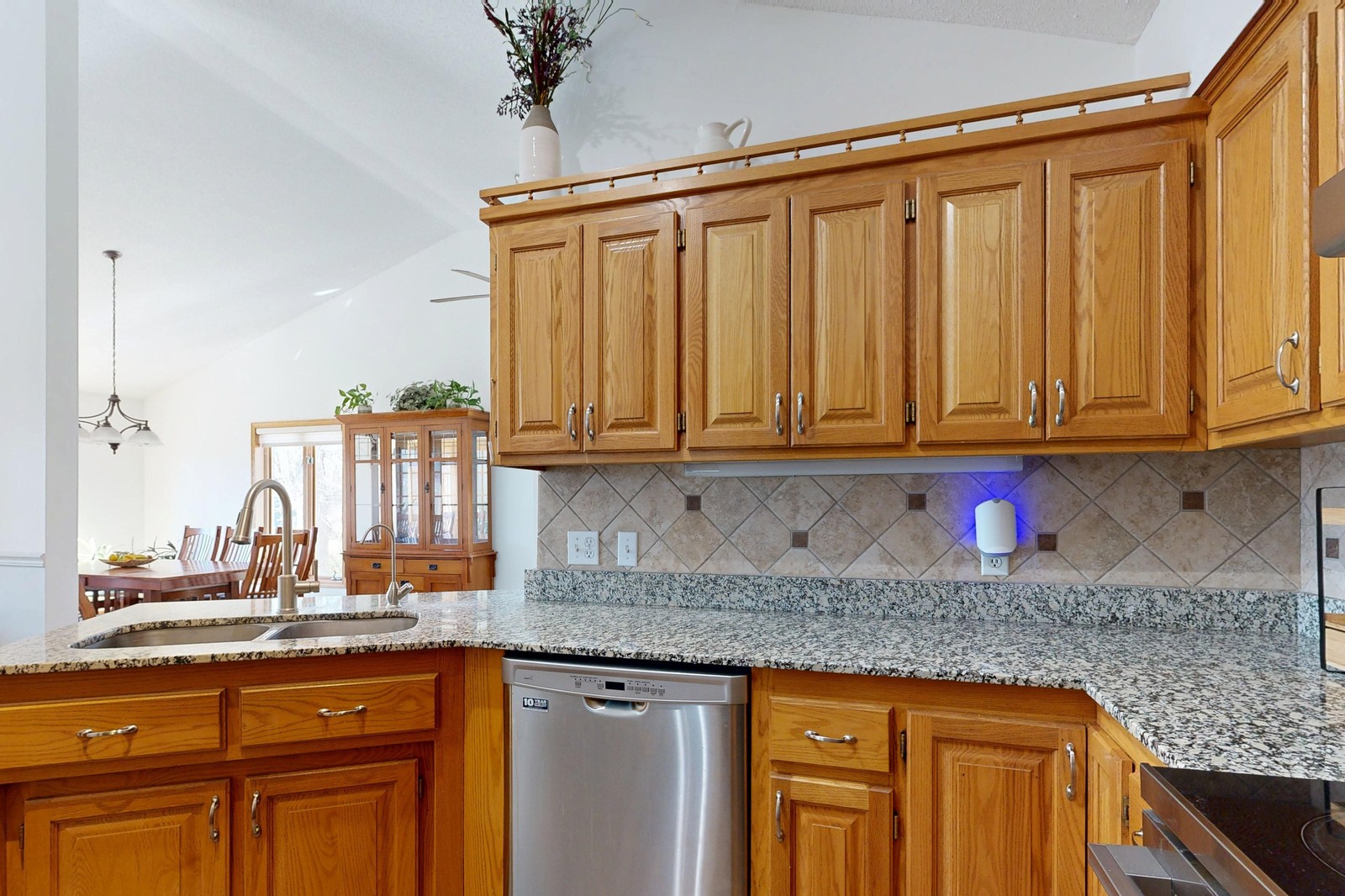 Built-in stainless steel dishwasher under the counter in a home kitchen