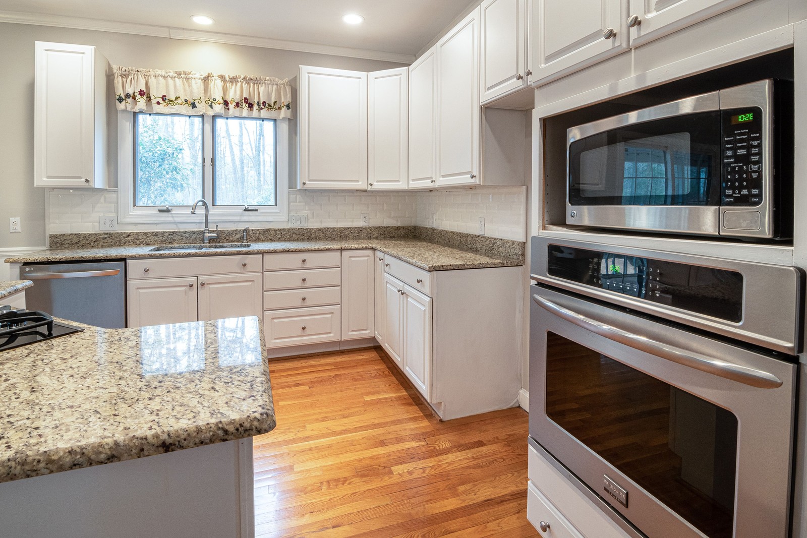 Built-in microwave and wall oven in a bright modern kitchen
