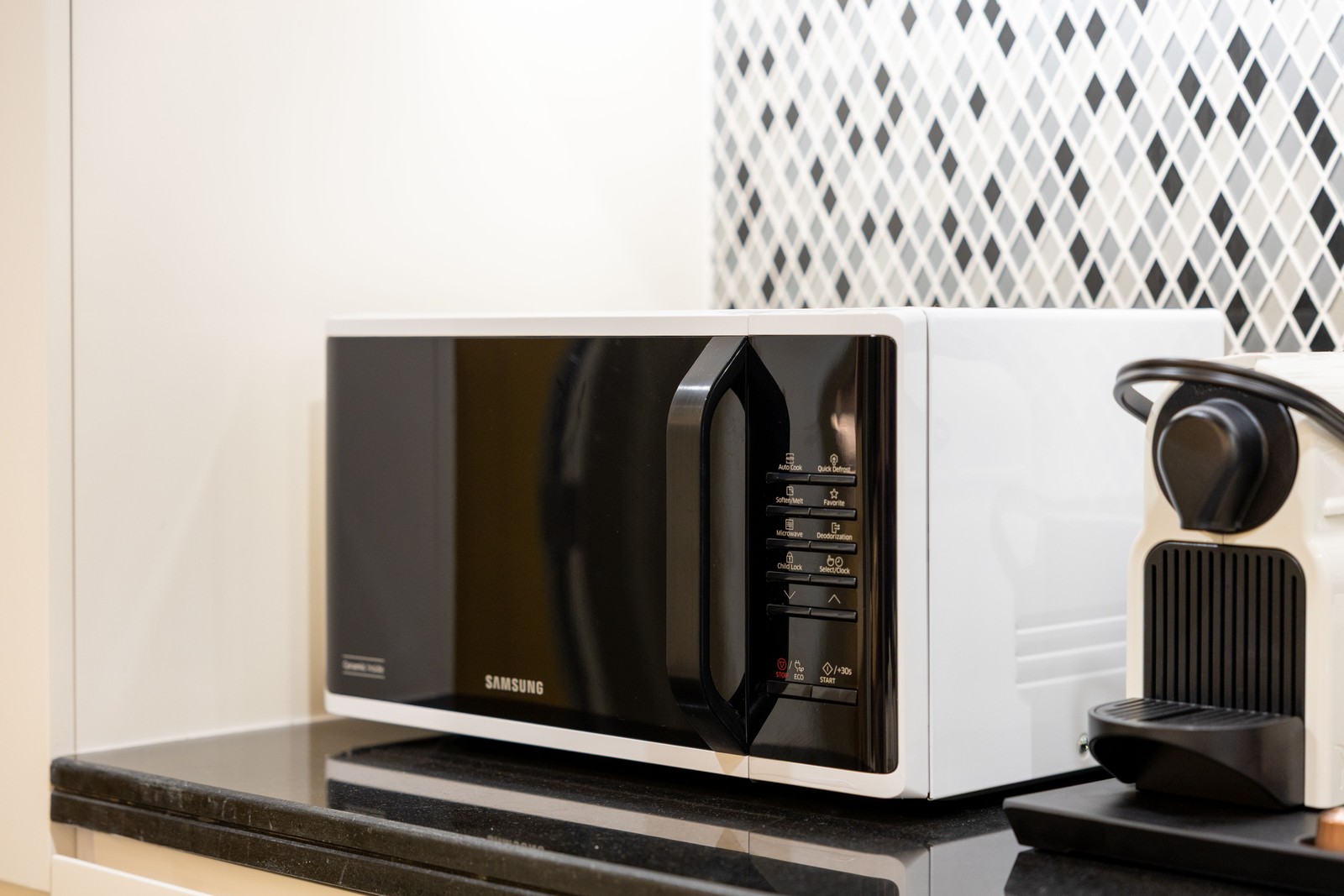 Countertop microwave on a kitchen counter next to a coffee machine