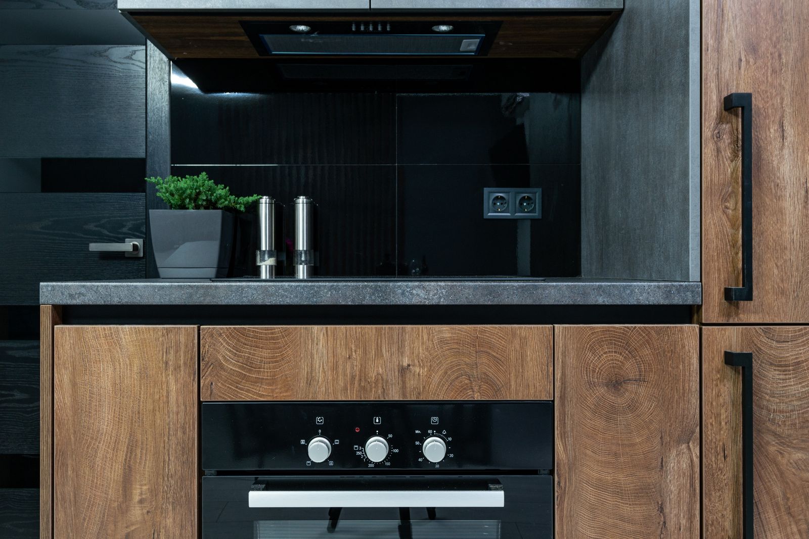 Built-in oven control dial in a modern kitchen