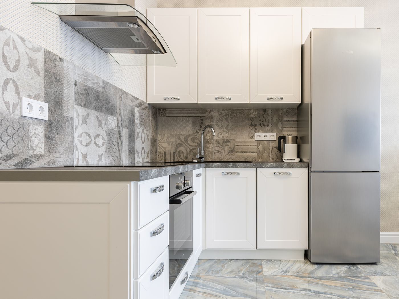 Stainless steel bottom-freezer refrigerator in a home kitchen